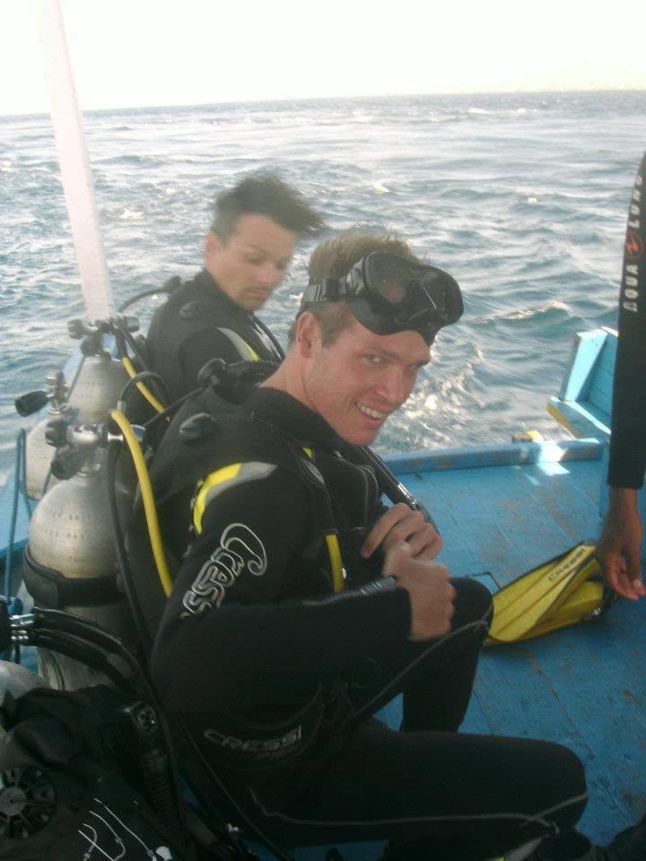 Luke McMillan on a dive boat during marine fieldwork